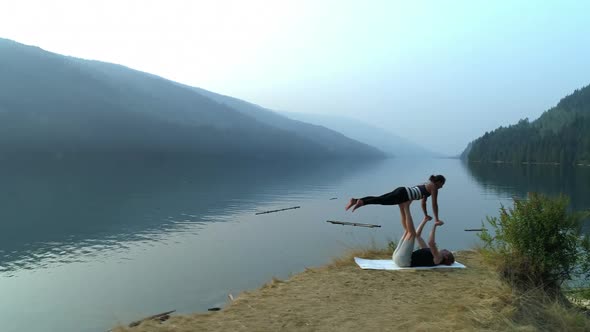 Two women practice acroyoga 4k