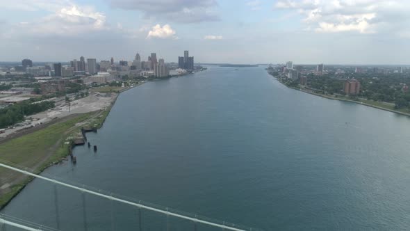 This video is about an aerial of the Ambassador Bridge over the Detroit river near downtown Detroit.