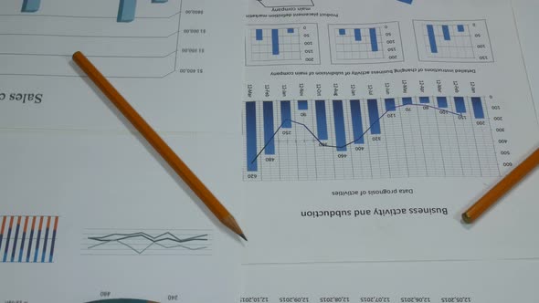 Business Graphs Of A Sales Company On A Desk In A Modern Office