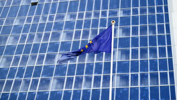 Footage EU Flag Fluttering on Strong Wind Against High Modern Business Center