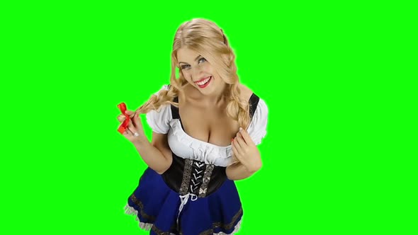 Girl in Bavarian Costume Touches Her Hair and Laughs. Green Screen. Slow Motion