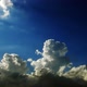 Fluffy clouds. 2 videos in 1 file. White clouds moving through a blue and orange sky. - VideoHive Item for Sale