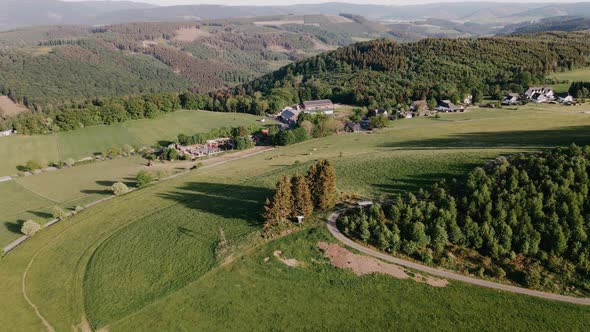 Drone View of Countryside in Green Hills and Fields in Sunny Weather