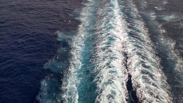 Still shot from rear of a cruiser. Mediterranean sea. Propulsion trail can be seen on the water from