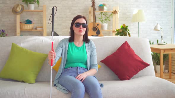 Portrait of a Young Blind Woman Disabled with a Cane for the Blind