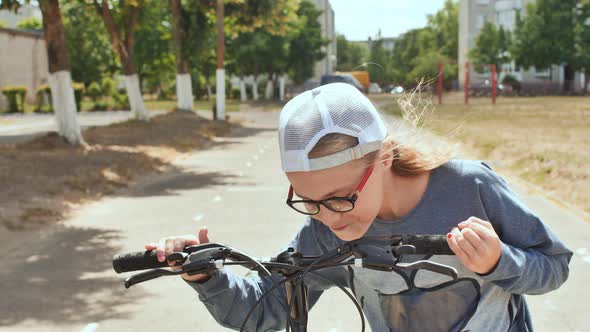 Teen Girl Kisses the Wheel of Her Favorite Bike