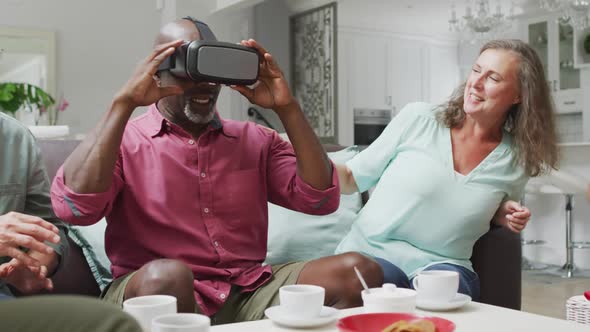 Animation of happy diverse female and male senior friends using vr headset and having fun