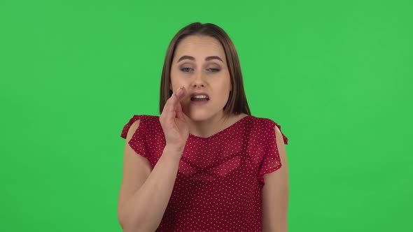Portrait of Tender Girl in Red Dress Is Screaming Calling Someone. Green Screen