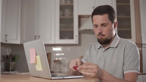 Adult Man Is Paying Online in Internet, Putting Data of Card in Site By Laptop