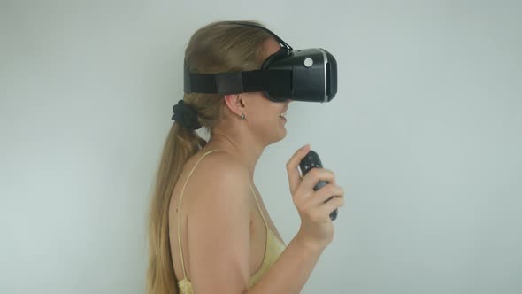 Sexy Woman Uses A Virtual Reality Helmet In A Simulation Game