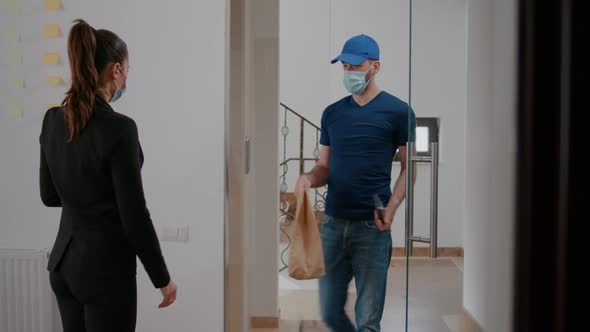 Delivery Guy with Medical Face Mask and Gloves Against Coronavirus Delivering Takeaway Food Meal