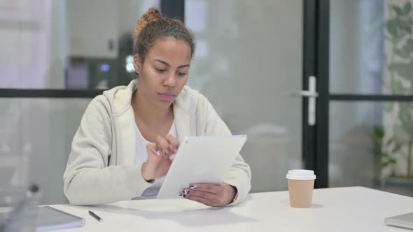 African Woman Using Tablet While Sitting in Office