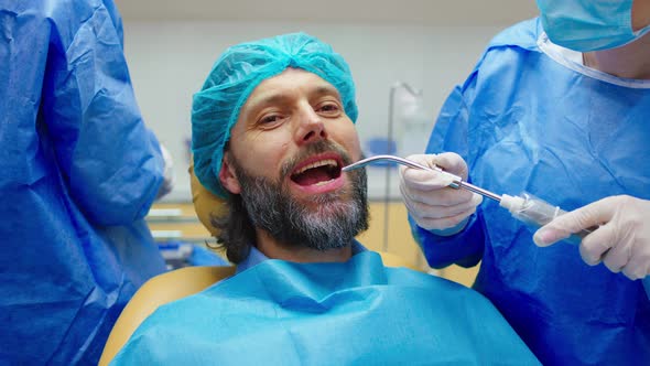 Porter of a Good Looking Mature Man on the Dentist