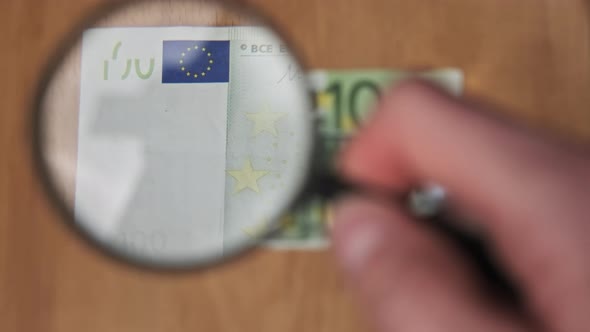 One Hundred Euro Under Magnifying Glass