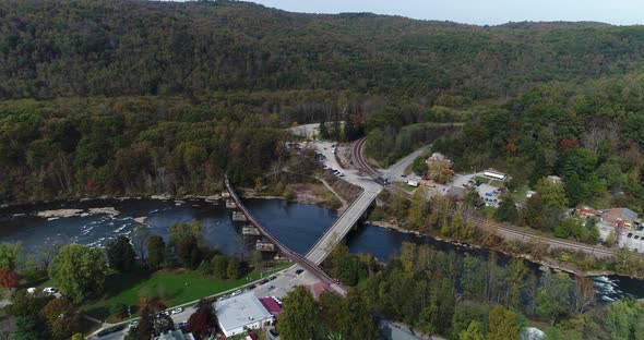 A high flyover view of the small town of Ohiopyle, Pennsylvania in early autumn. The Youghiogheny Ri