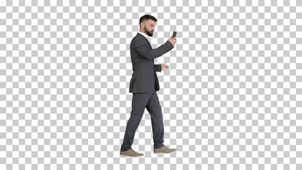 Handsome businessman walking and recording, Alpha Channel