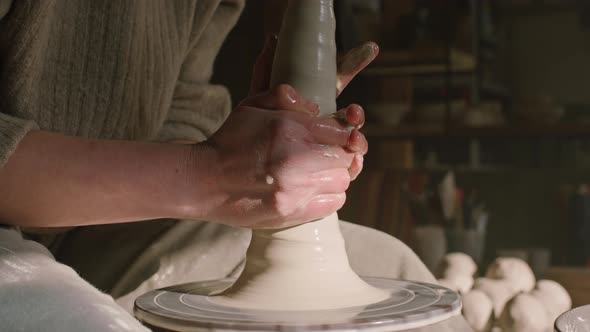 Potter Is Lifting Wet Clay Up On Potter's Wheel