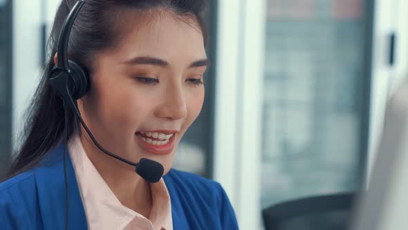 Businesswoman Wearing Headset Working Actively in Office