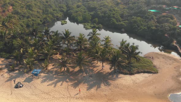 Arambol Sweet Water lake oasis near Arambol Beach in Goa, India - Aerial Fly way Reveal shot