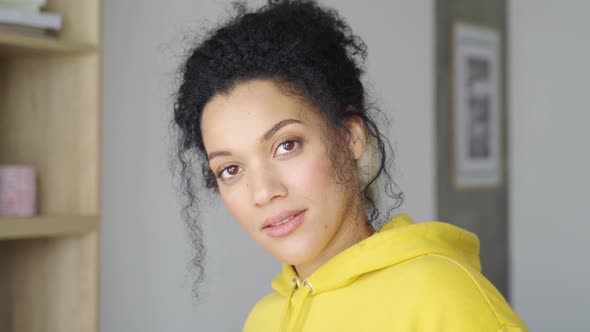 Headshot Portrait of Young Mixed Raced Woman Looking at Camera Indoors