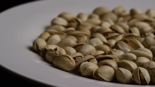 Cinematic, rotating shot of pistachios on a white surface - PISTACHIOS 022