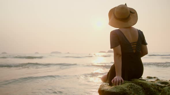 Happiness clam asian female traveller casual cloth with sun hat sit relax enjoy