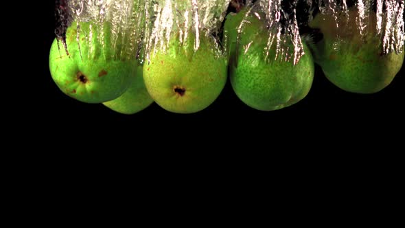 Super Slow Motion Pears Fall Under the Water with Air Bubbles