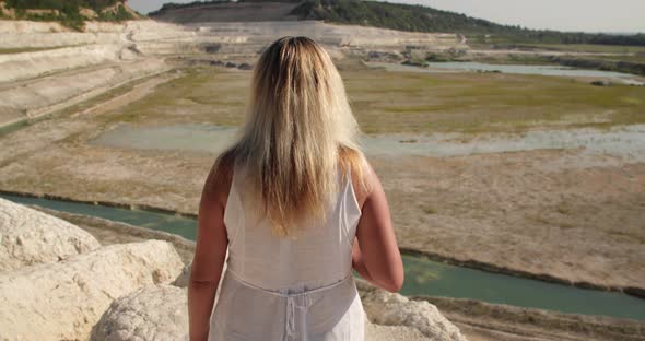 A Woman Approaches the Edge of the Cliff