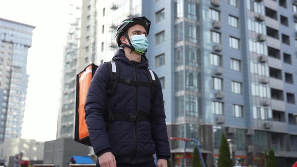 Food Courier in Face Mask Walking Delivering Order