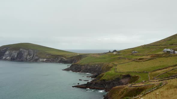 Aerial Descending Shot of Coastal Landscape with Meadows and Pastures