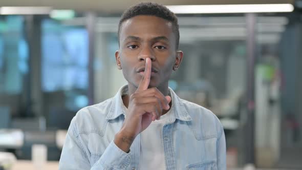 Portrait of African Man Showing Quiet Sign, Finger on Lips