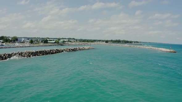 Aerial Wide Drone View of Stone Embankment or Breakwater at Sea with Sandy Beach and Silent Water