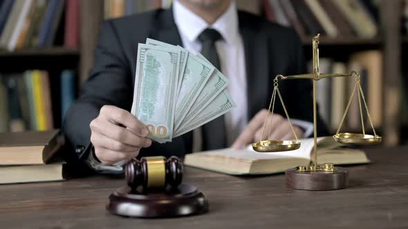 Close Up Shoot of Judge Hand Holding Money in Court Room