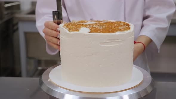 The Cook Aligns the Cake with a Metal Pastry Spatula in a Pastry Shop