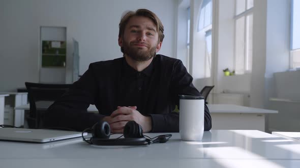 Young Man Sits and Talks on the Camera