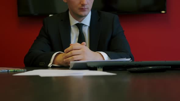 Businessman in Formal Wear Carefully Reading Contract Terms of Conditions Putting Signature on Paper
