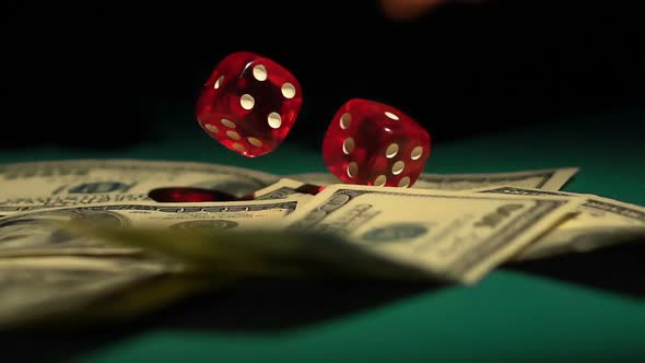 Red Dice Falling on Money, Gambler Playing Game at Casino, Addiction to Gambling