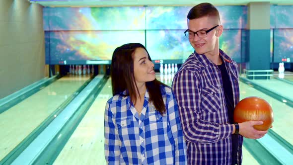 Boy and Girl Look at Each Other at the Bowling 1080p