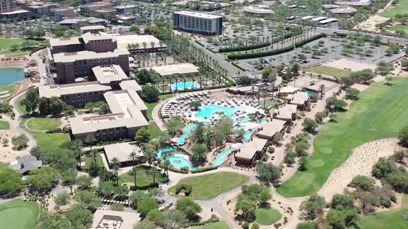 Aerial view of an amazing luxury travel destination panning down over a stunning pool.