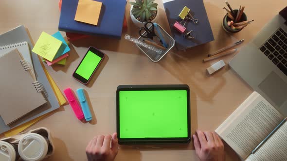 Student Using Gadget with Chroma Key Screen Top View