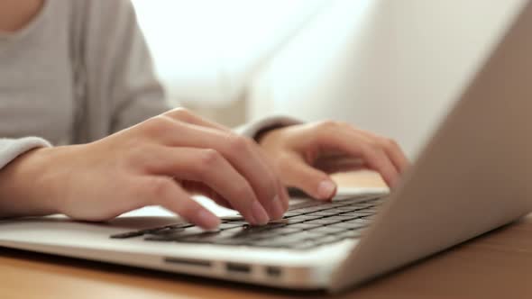 Woman working on laptop computer at home