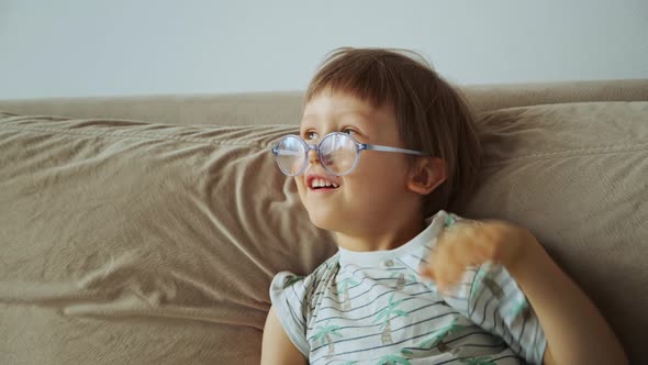 Tired Unhappy From Homeschooling Child Using Laptop Sitting on Sofa at Home