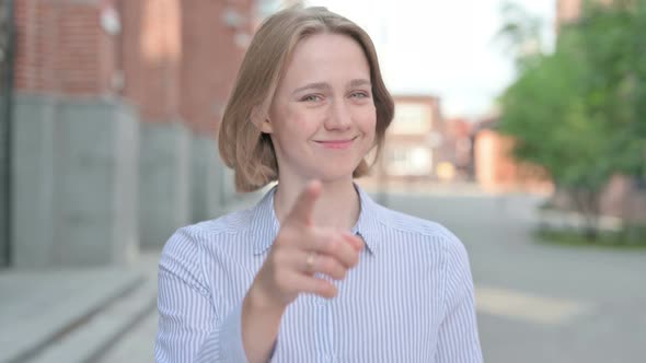 Portrait of Woman Pointing at the Camera