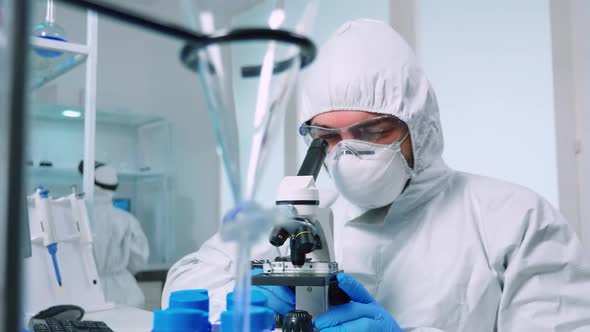 Biotechnology Scientist in Ppe Suit Researching DNA