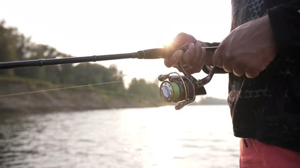 a man fishing at sunset