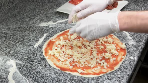 Hands Preparing Pizza