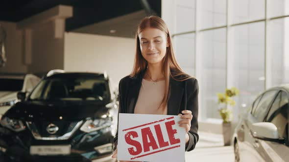 Smiling Caucasian Woman in Casual Clothes Standing at Modern Auto Salon and