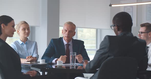 Happy Businesspeople Shaking Hands Greeting Each Other at Business Meeting in Office