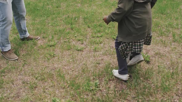 Father and Son Playing Football in Park