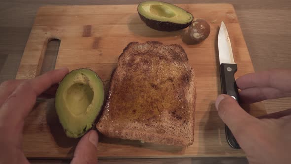 Slice Of Toast Bread With Avocado - Person Making Healthy Breakfast. - close up